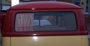 Rhubarb and Custard splitscreen camper van with old curtains