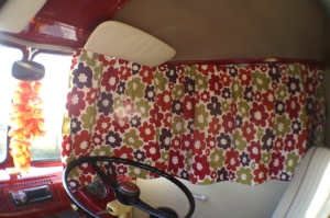 VW Campervan Curtains in Clarke and Clarke Anja Summer fabric in a splitscreen van with a lei