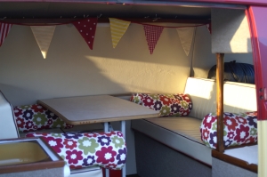 VW Campervan Curtains and cushions in Clarke and Clarke Anja Summer fabric in a splitscreen van interior with bunting