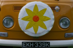 vw bay window orange camper flower spare tyre field of dreams