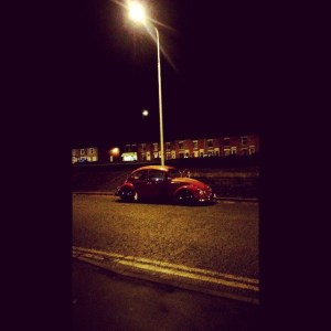 red vw beetle patina slammed night streetlight